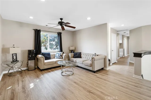 a bedroom with a bed wooden floor and window