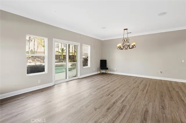 a view of a livingroom with wooden floor and a window
