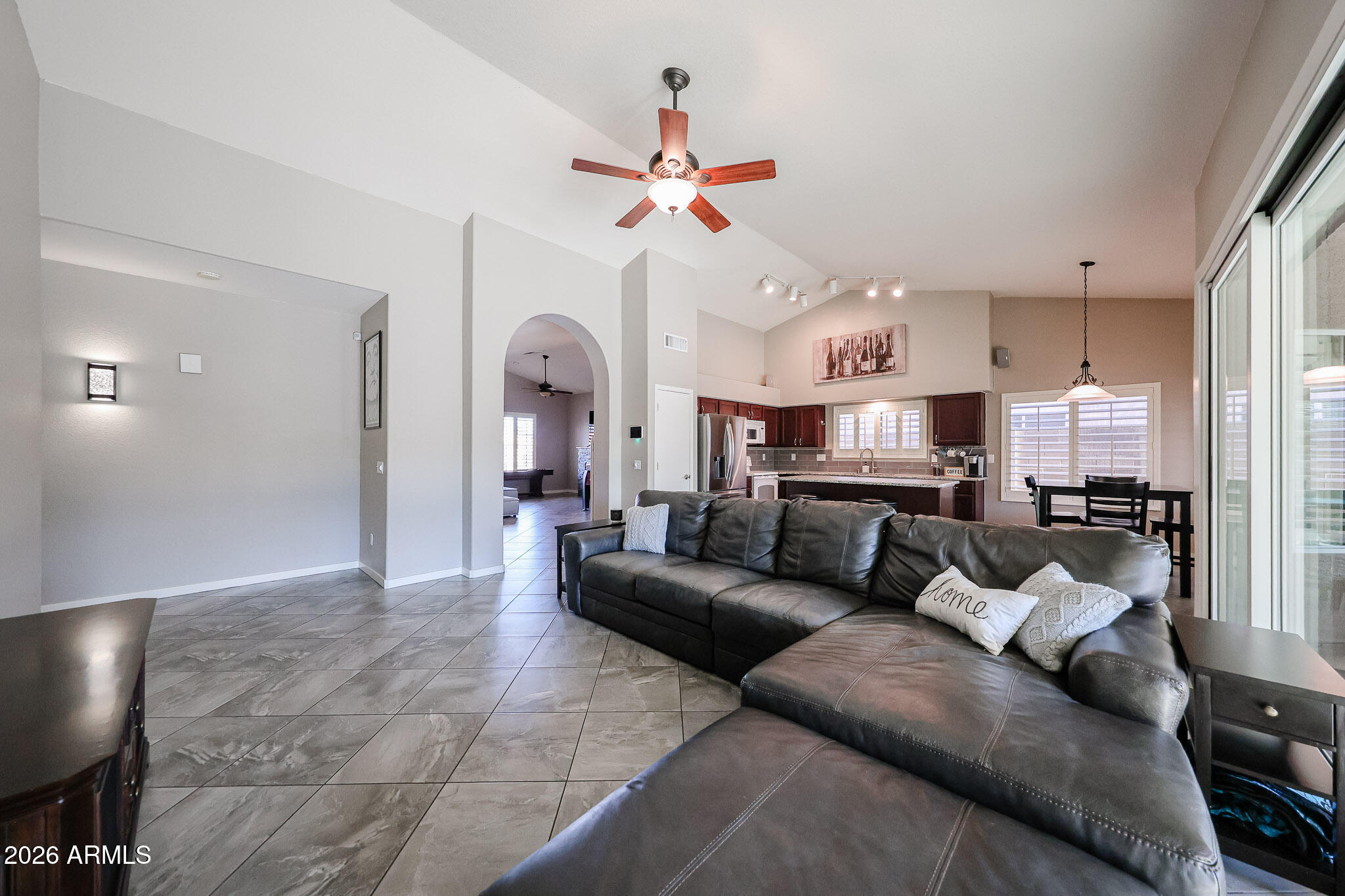 7733 West Rue De Lamour Peoria, AZ 85381 - Photo 21 of 62 a living room with furniture kitchen view and a chandelier