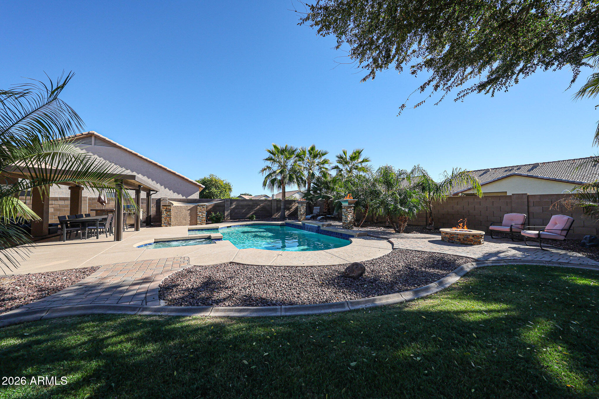 7733 West Rue De Lamour Peoria, AZ 85381 - Photo 46 of 62 a view of a house with a yard