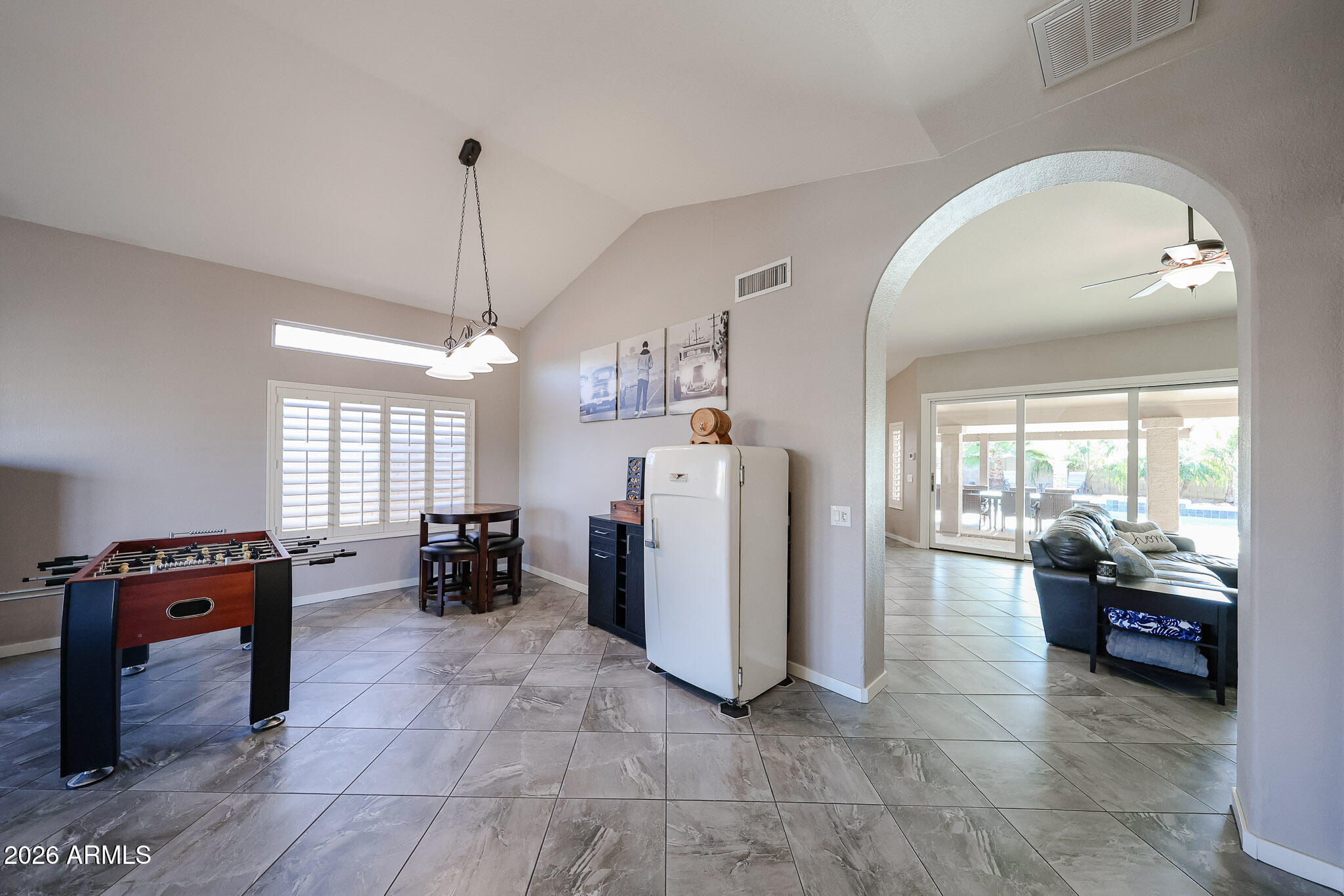 7733 West Rue De Lamour Peoria, AZ 85381 - Photo 7 of 62 a living room with furniture and a chandelier
