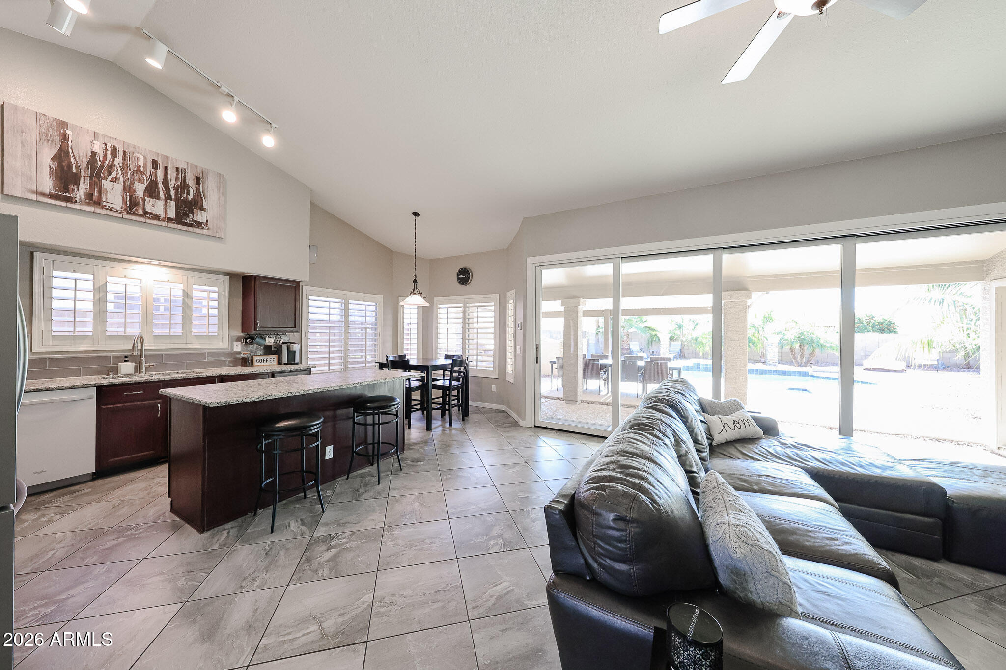 7733 West Rue De Lamour Peoria, AZ 85381 - Photo 10 of 62 a large living room with a large window and a couch