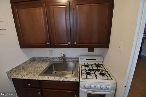 a kitchen with a sink stove and cabinets