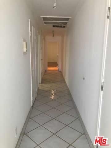 a view of a hallway with wooden floor and entryway