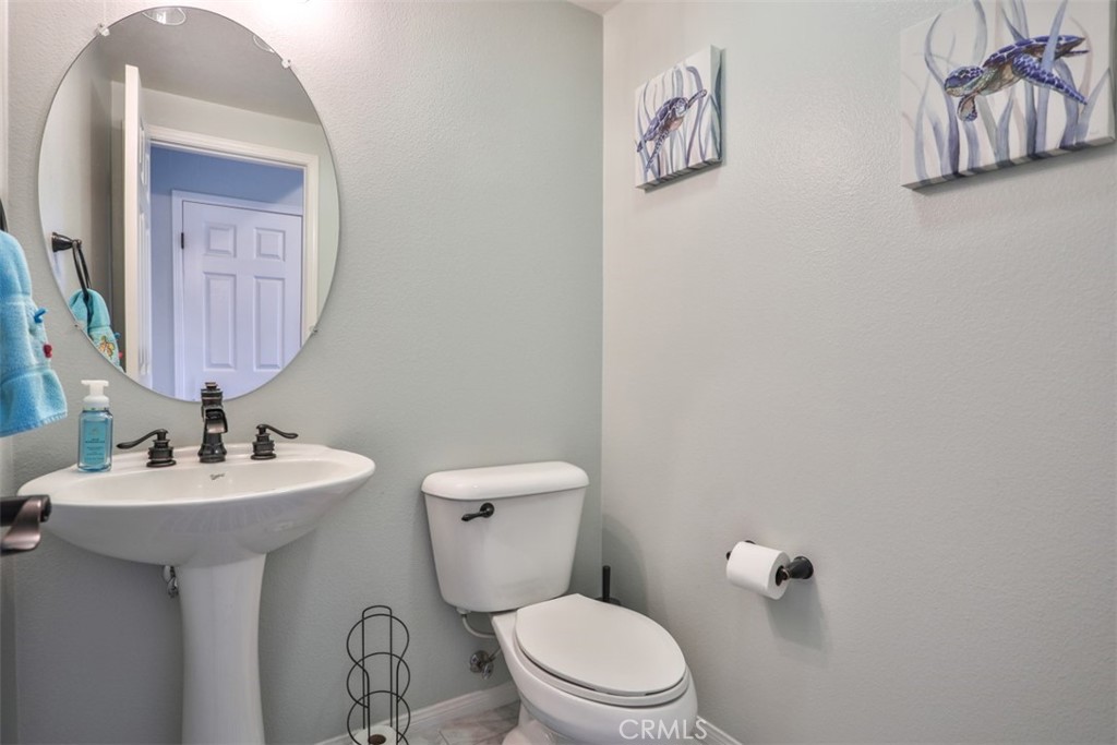 3250 Quartz Circle Corona, CA 92882 - Photo 12 of 68 a bathroom with a toilet sink and mirror