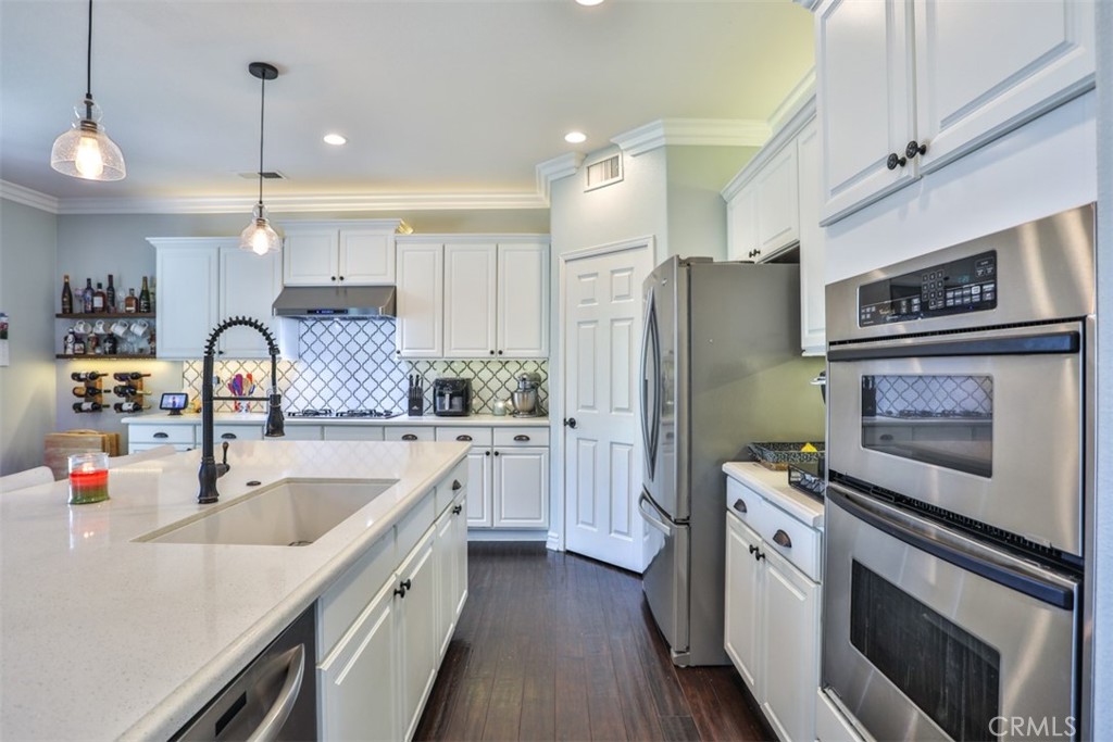 3250 Quartz Circle Corona, CA 92882 - Photo 17 of 68 a kitchen with a sink stove and refrigerator