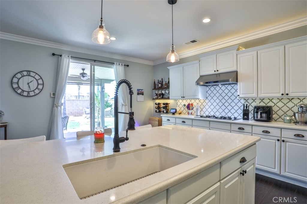 3250 Quartz Circle Corona, CA 92882 - Photo 18 of 68 a kitchen with a sink a counter space appliances and cabinets