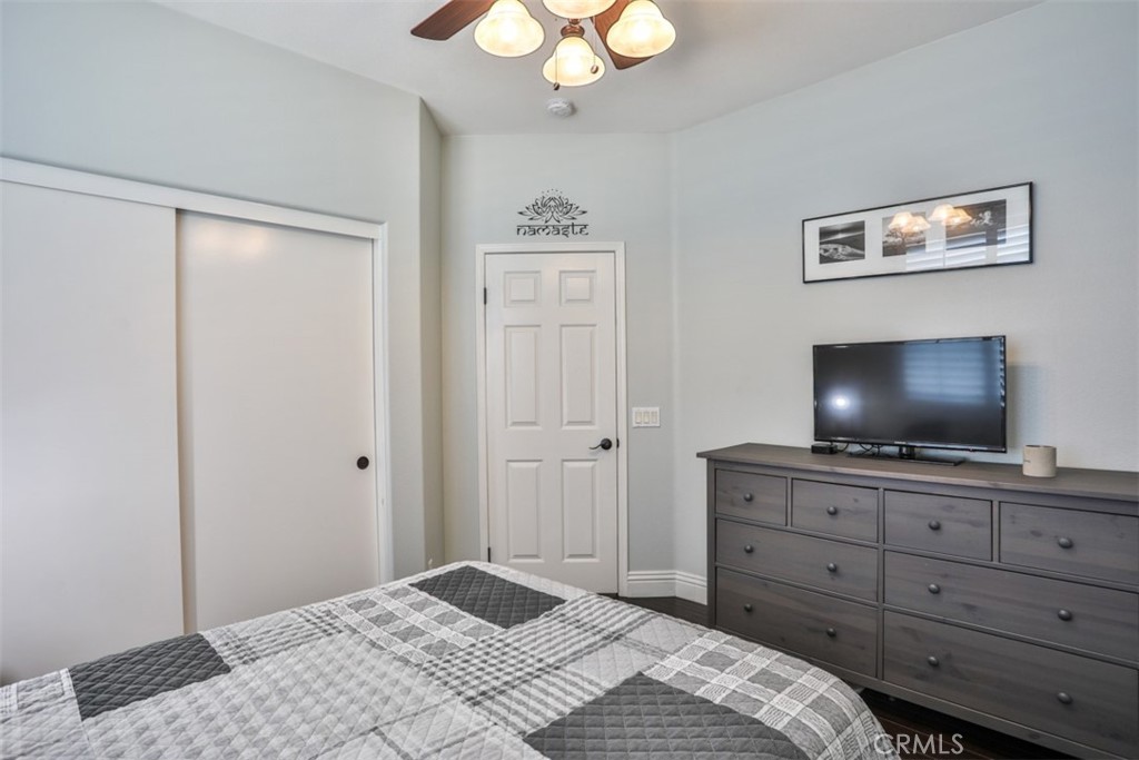 3250 Quartz Circle Corona, CA 92882 - Photo 27 of 68 a bedroom with a bed and a flat screen tv