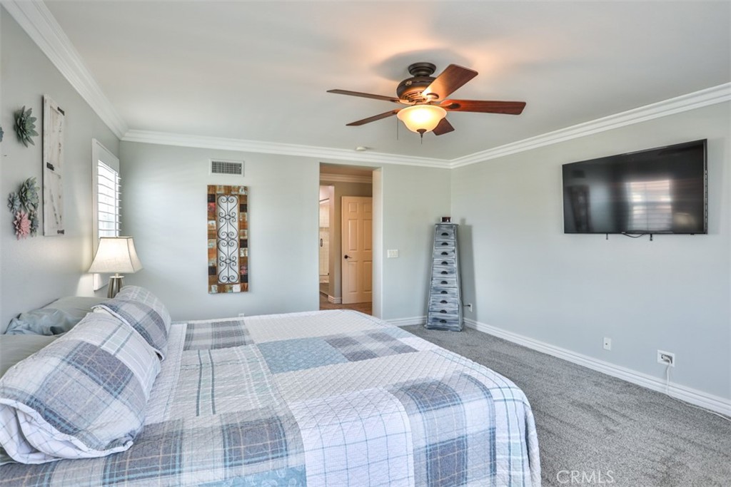 3250 Quartz Circle Corona, CA 92882 - Photo 34 of 68 a bedroom with a large bed and a flat screen tv