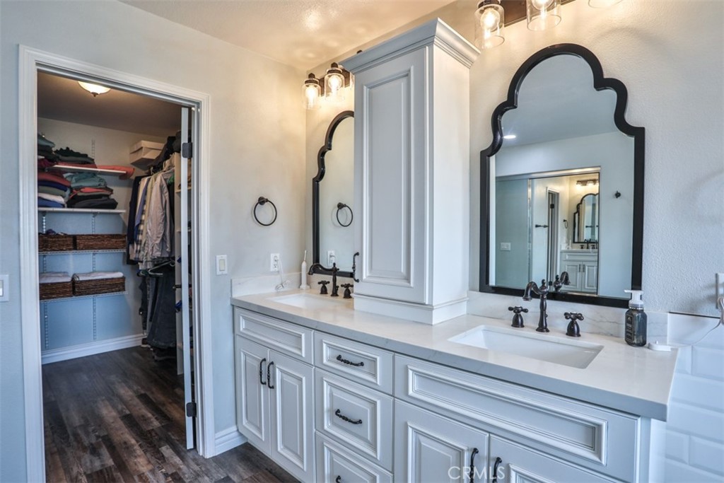 3250 Quartz Circle Corona, CA 92882 - Photo 36 of 68 a bathroom with a double vanity sink and a mirror