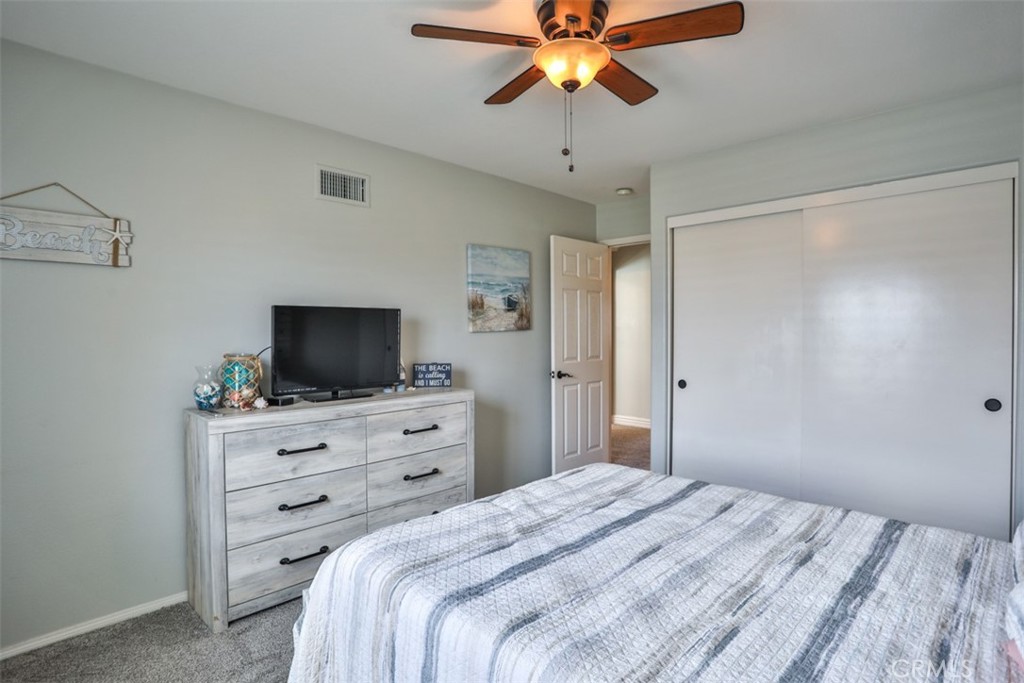 3250 Quartz Circle Corona, CA 92882 - Photo 40 of 68 a bedroom with a bed and a flat tv screen on dresser
