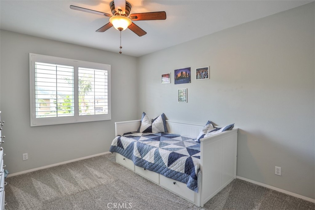 3250 Quartz Circle Corona, CA 92882 - Photo 41 of 68 a bedroom with a bed and a chandelier fan