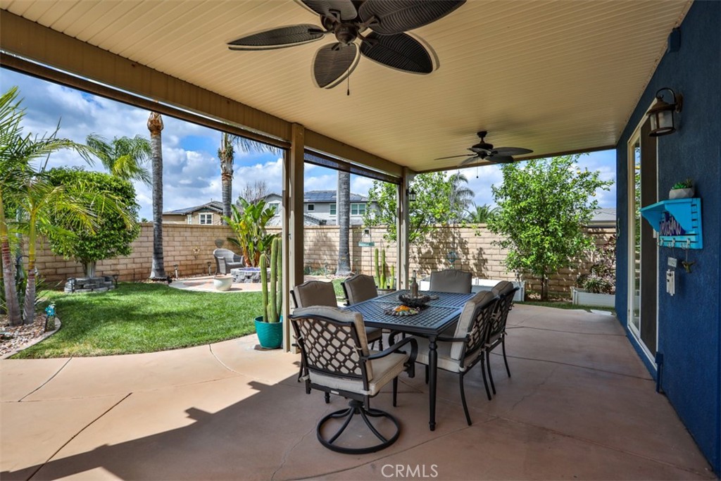 3250 Quartz Circle Corona, CA 92882 - Photo 49 of 68 a patio with table and chairs and potted plants