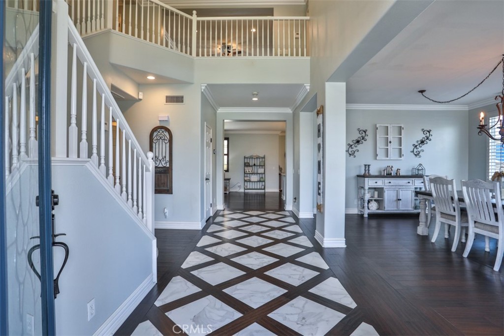 3250 Quartz Circle Corona, CA 92882 - Photo 7 of 68 a view of a hallway with dining room and wooden floor