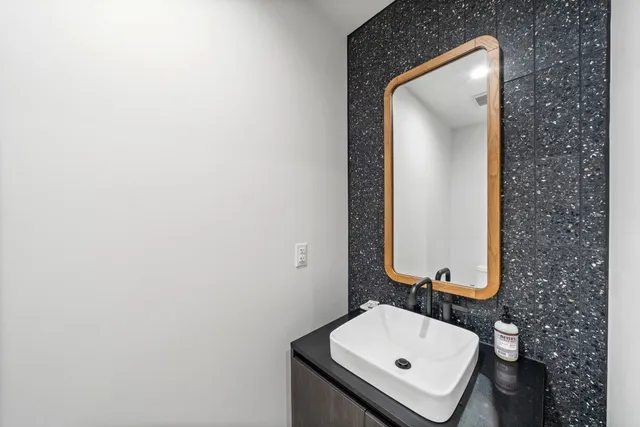 a bathroom with a sink and a mirror