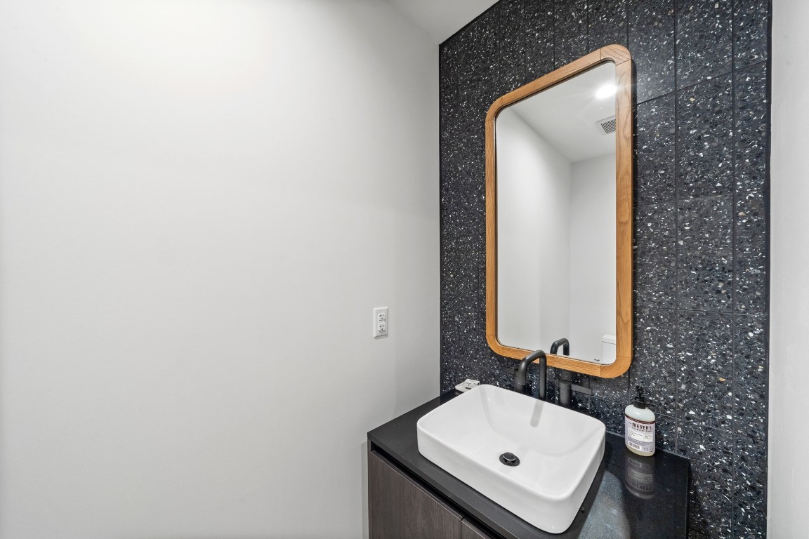 48 East Avenue, Unit 2511 Austin, TX 78701 - Photo 18 of 40 a bathroom with a sink and a mirror