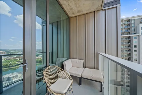 a balcony with table and chairs