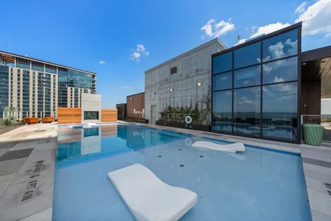 a view of a swimming pool and lounge chair