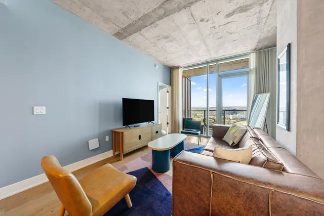 a living room with furniture and a flat screen tv