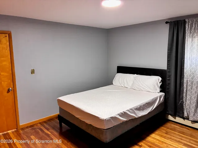 a bed sitting in a bedroom next to a window