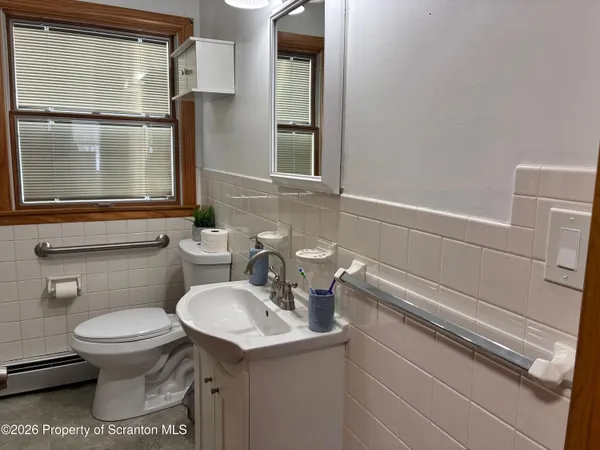 a bathroom with a sink toilet and mirror