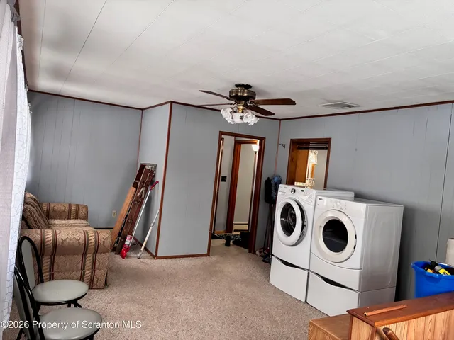 a view of a storage and utility room with washer and dryer
