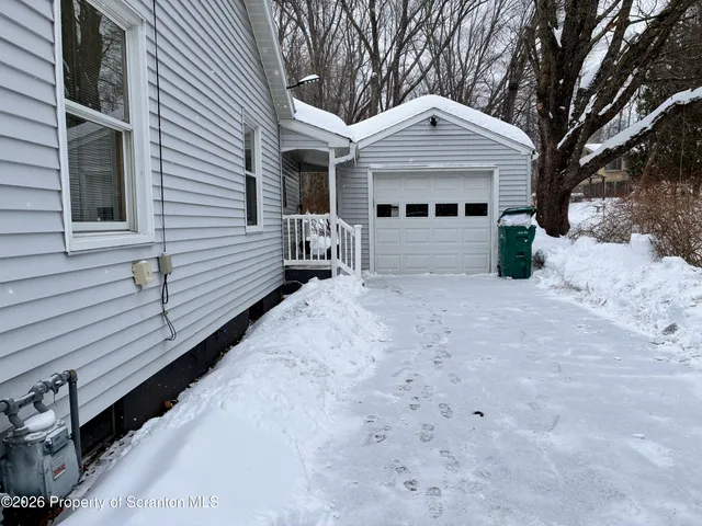 a front view of a house with yard and garage