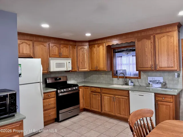 a kitchen with a sink appliances and cabinets