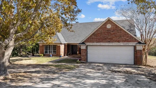 a view of a house with a yard and garage