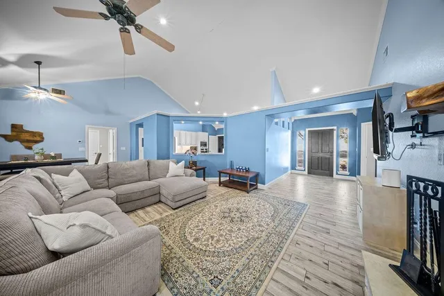 a living room with furniture and a ceiling fan