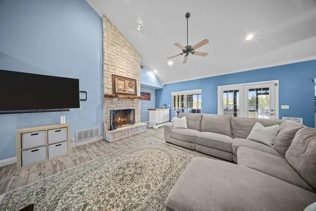 a living room with furniture a flat screen tv and a fireplace