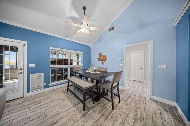 a living room with furniture a dining table and a window