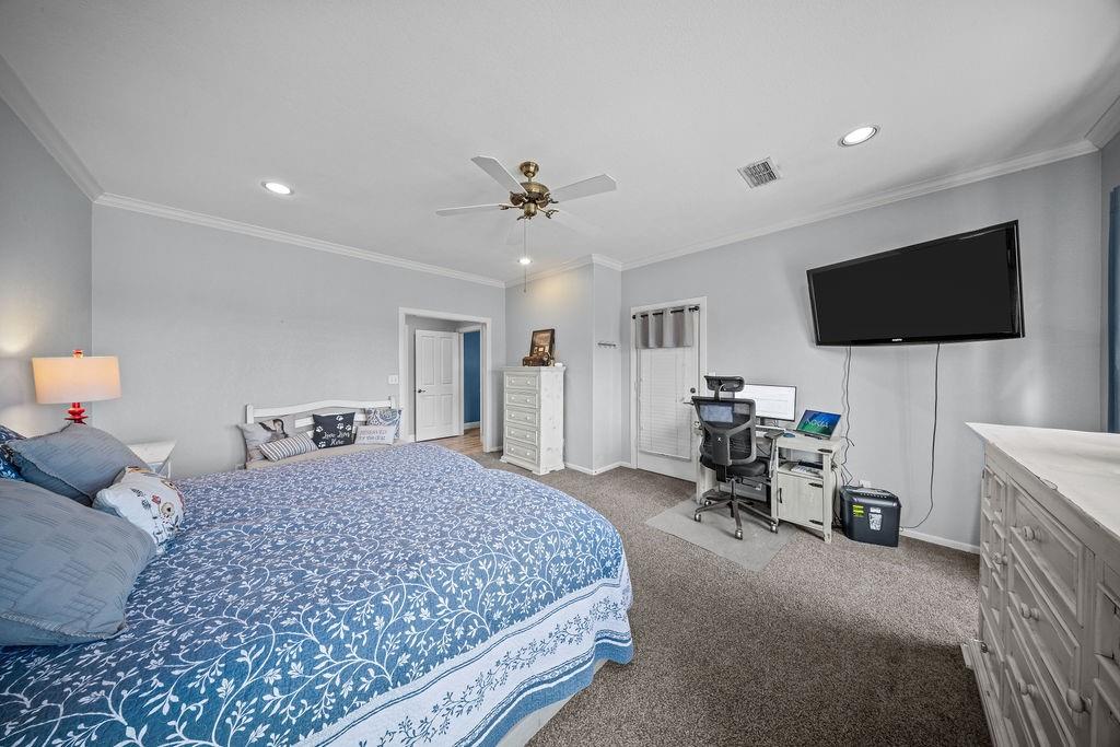 831 Union Hill Road Ennis, TX 75119 - Photo 17 of 36 a bedroom with a bed and a flat screen tv