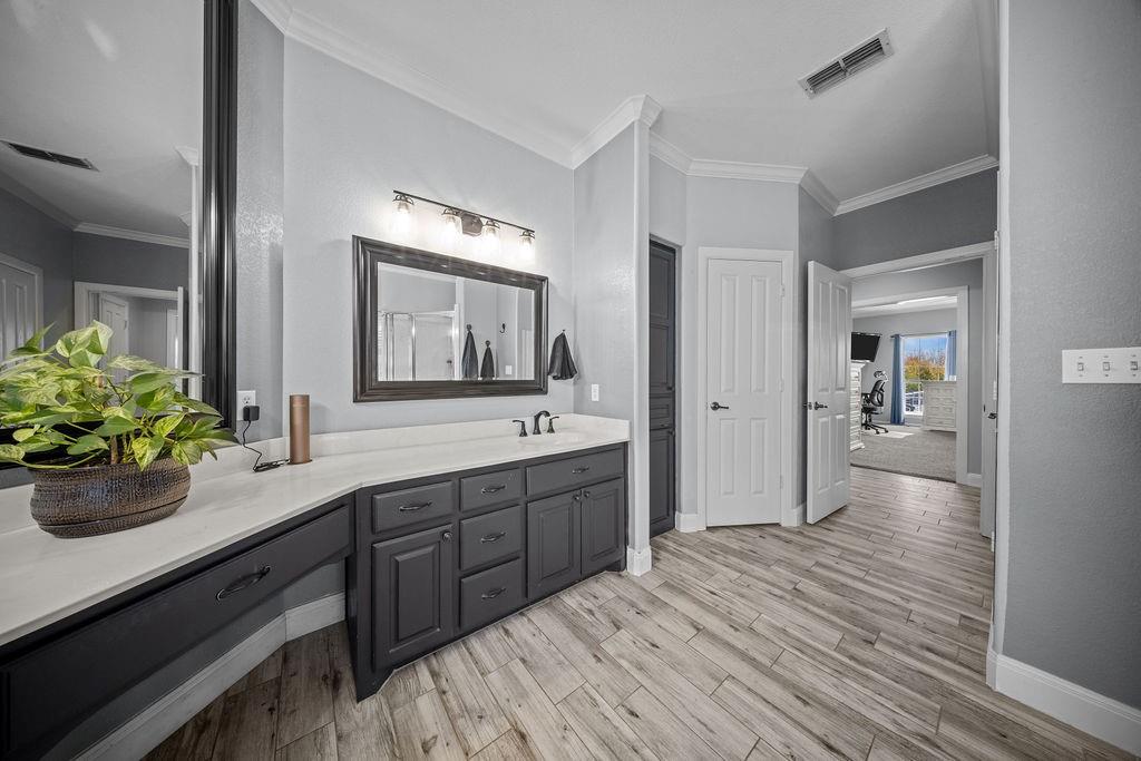831 Union Hill Road Ennis, TX 75119 - Photo 18 of 36 a spacious bathroom with a sink a mirror and a potted plant