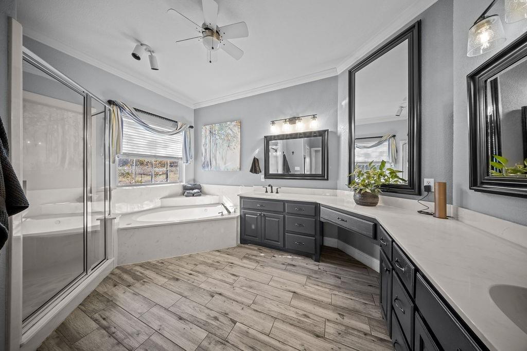 831 Union Hill Road Ennis, TX 75119 - Photo 20 of 36 a large bathroom with a large tub sink vanity granite and a large mirror