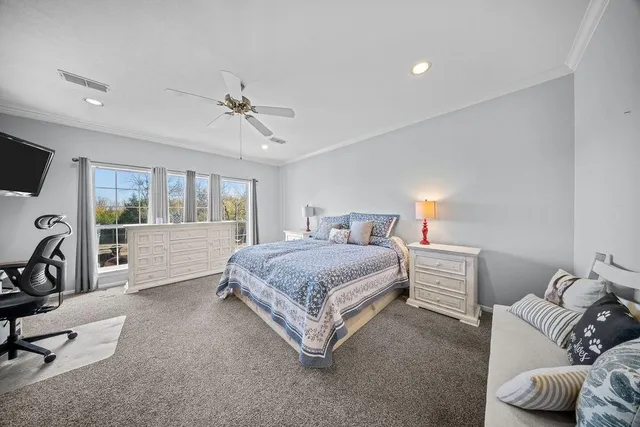 a living room with a bed furniture and a flat tv screen