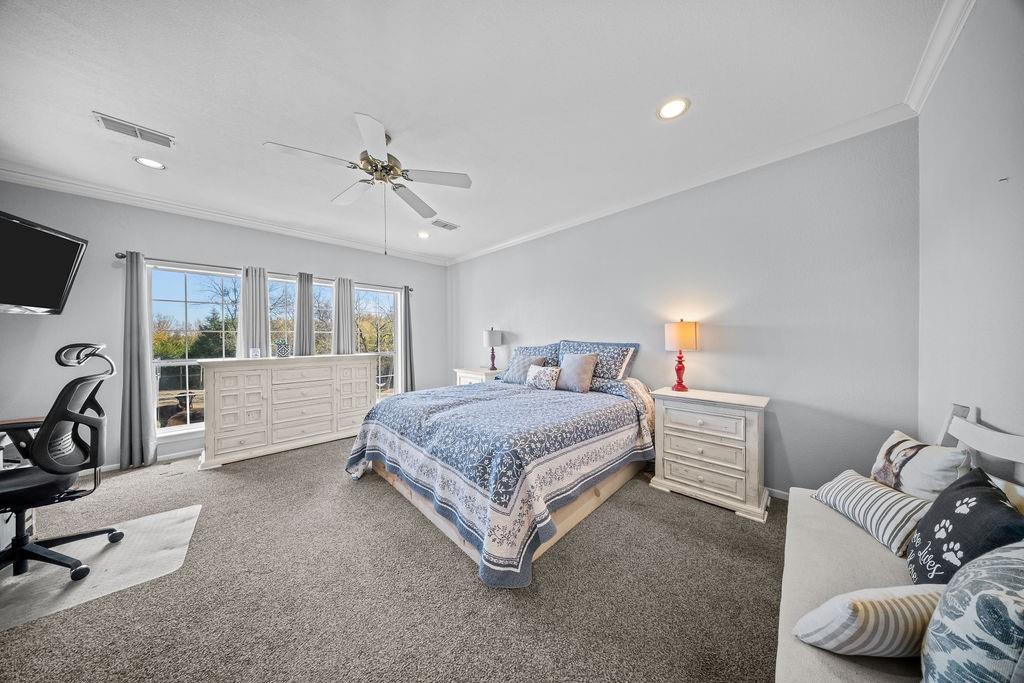831 Union Hill Road Ennis, TX 75119 - Photo 23 of 36 a living room with a bed furniture and a flat tv screen
