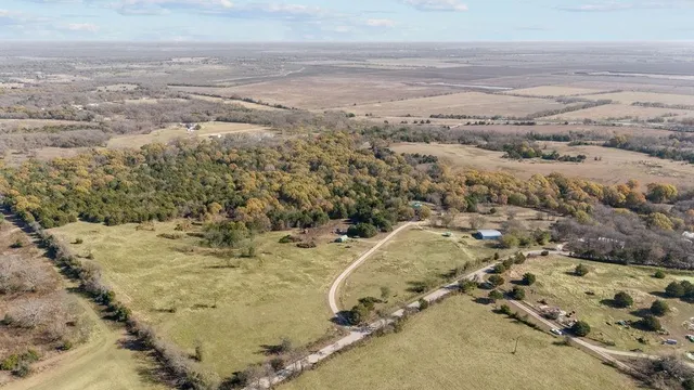 a view of a house with swimming pool and a yard