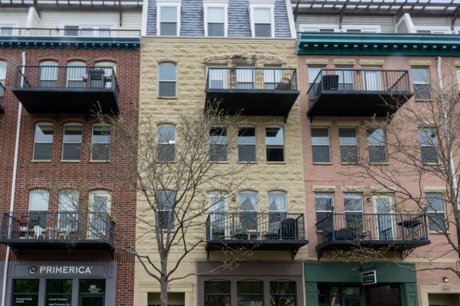 339 Front Street, Unit 2207 Lemont, IL 60439 - Photo 1 of 27 a front view of a building with many windows
