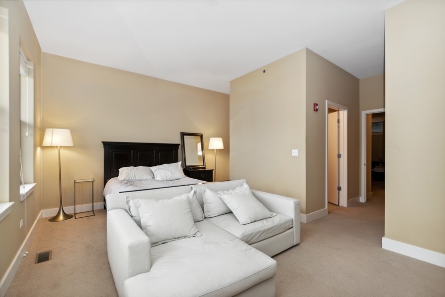 339 Front Street, Unit 2207 Lemont, IL 60439 - Photo 12 of 27 a bedroom with a bed and a night stand