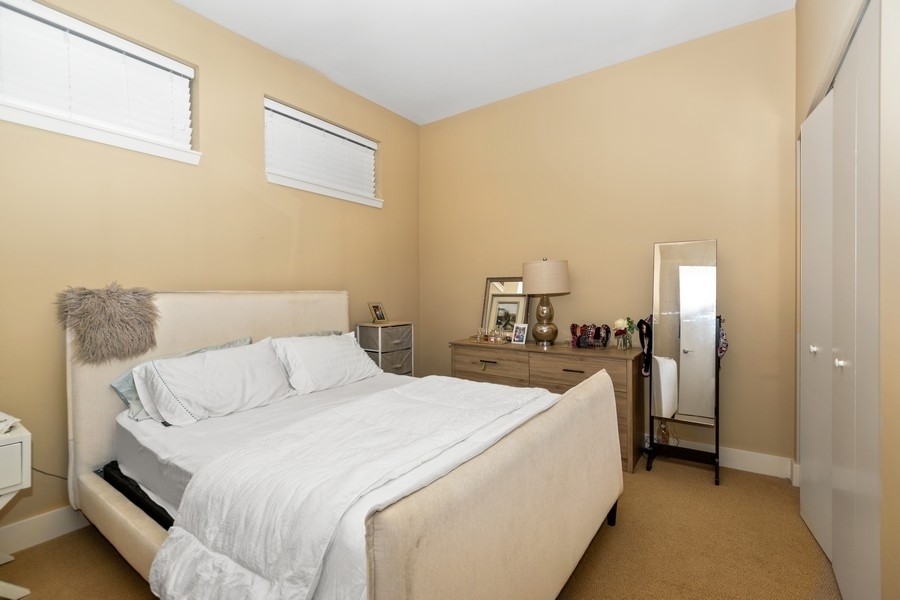 339 Front Street, Unit 2207 Lemont, IL 60439 - Photo 16 of 27 a view of a bedroom with a bed and a couch
