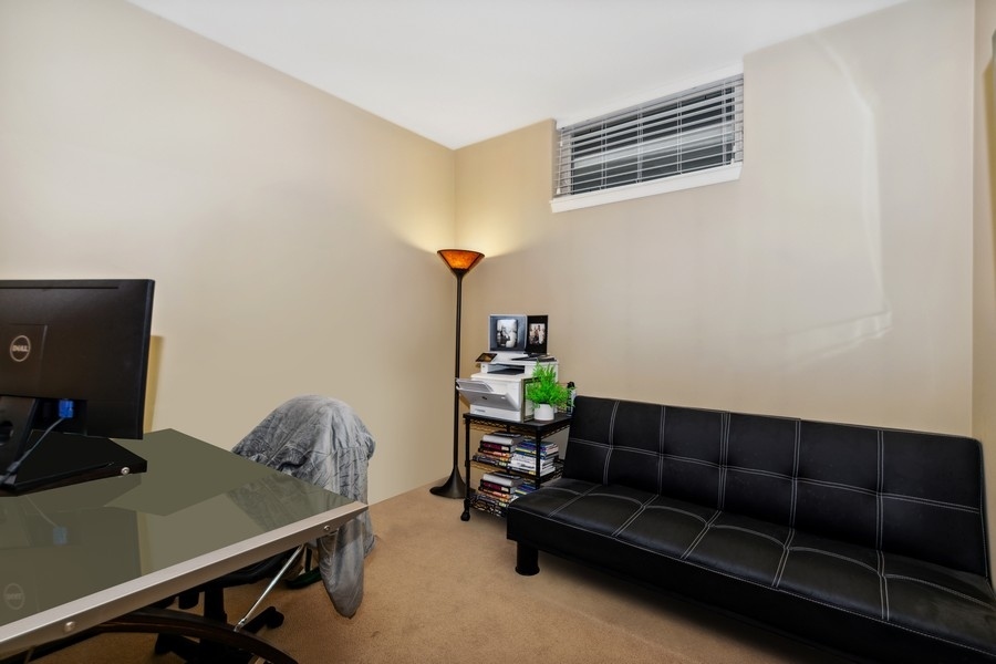339 Front Street, Unit 2207 Lemont, IL 60439 - Photo 18 of 27 a room with furniture wall paintings and a window