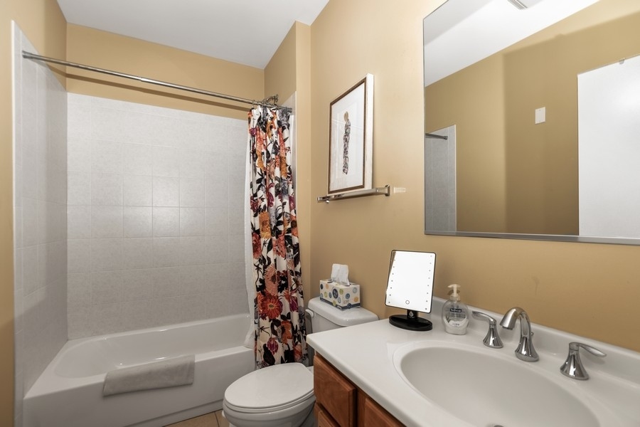 339 Front Street, Unit 2207 Lemont, IL 60439 - Photo 19 of 27 a bathroom with a sink toilet and shower