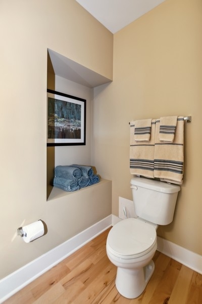 339 Front Street, Unit 2207 Lemont, IL 60439 - Photo 21 of 27 a white toilet sitting next to a bathroom sink and vanity