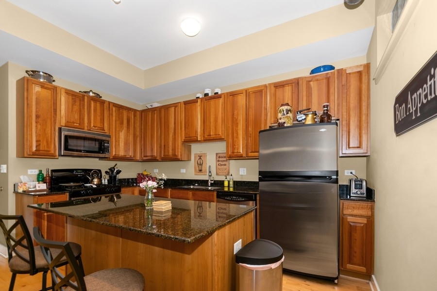 339 Front Street, Unit 2207 Lemont, IL 60439 - Photo 5 of 27 a kitchen with a refrigerator a stove a sink and a microwave