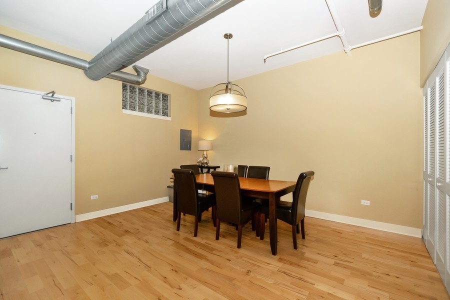 339 Front Street, Unit 2207 Lemont, IL 60439 - Photo 8 of 27 a view of a dining room with furniture and wooden floor