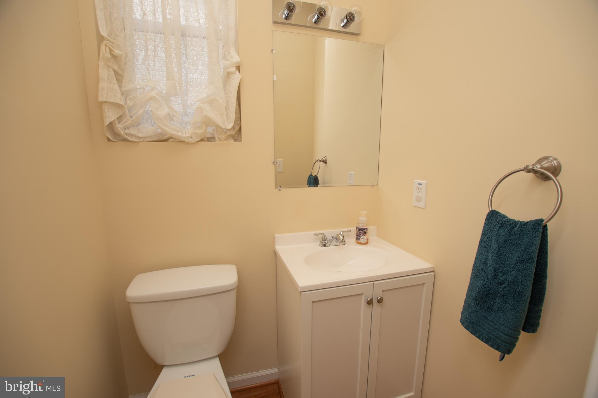 67 Edmondson Ridge Road Baltimore, MD 21228 - Photo 23 of 41 a bathroom with a toilet sink and mirror