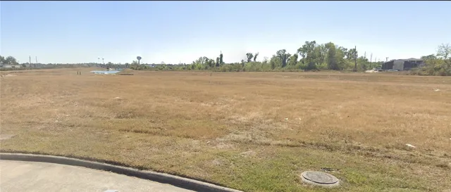 a view of a lake with trees and buildings in the background