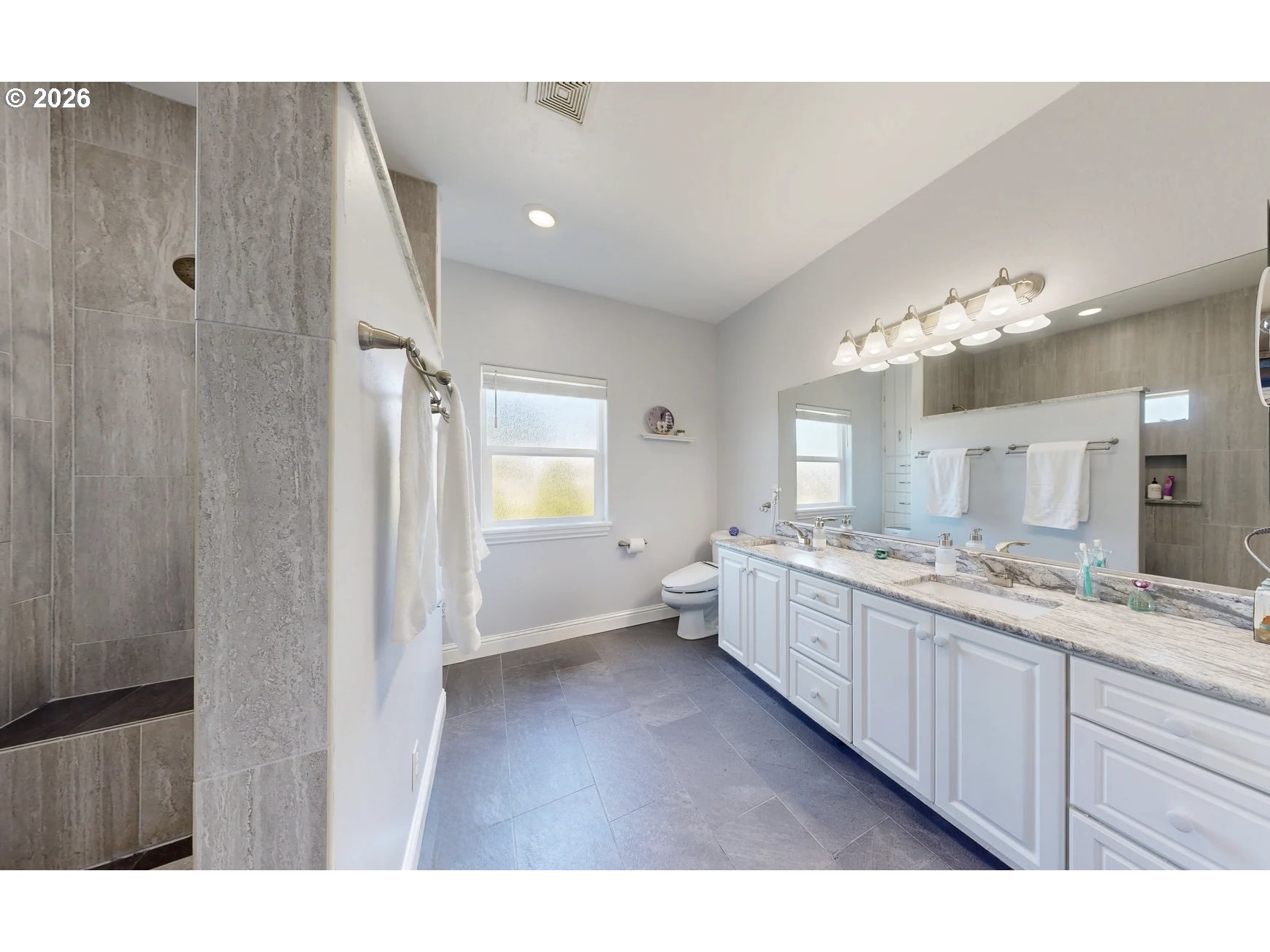 842 Chetco Point Terrace Brookings, OR 97415 - Photo 20 of 33 a large bathroom with a granite countertop double vanity sink a mirror and a bathtub
