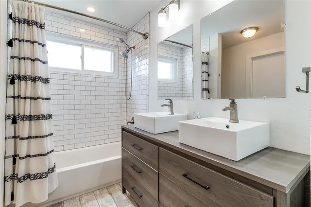 a bathroom with a sink a bathtub and a shower